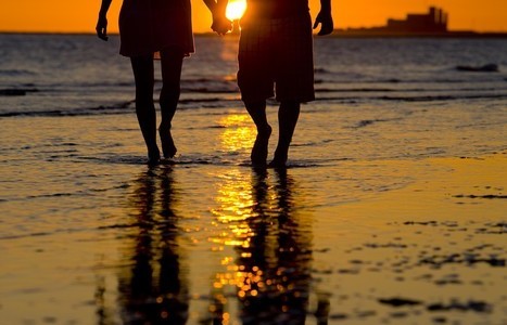 A couple on the beach at sunset